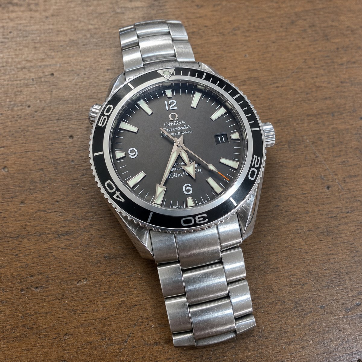 Stainless steel watch on a wood counter